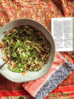 Munching on a fresh salad while reading